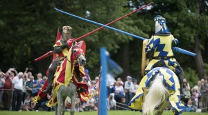 FILE - In this file photo dated July 5, 2014, People are dressed as knights on horseback take part in a medieval jousting tournament at Linlithgow Palace, Linlithgow, Scotland. The charity English Heritage has launched a campaign Thursday July 20, 2016, for the ancient equestrian sport of Jousting to be included on the program at future Summer Olympic Games. (Jane Barlow / PA FILE via AP)