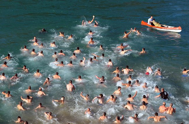 Christian Orthodox believers swim across cold water for a cross in the river Ribnica, in Podgorica, Montenegro, marking Orthodox Epiphany, Tuesday, Jan. 19, 2016. Orthodox Serbs celebrate Epiphany on January 19, following the old Julian calendar, with the tradition of retrieving crosses from the rivers and lakes. (AP Photo/Risto Bozovic)